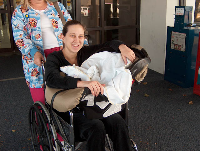 Finally leaving the hosptial! (And yes, Abby can walk -- they make you ride in a wheelchair.)