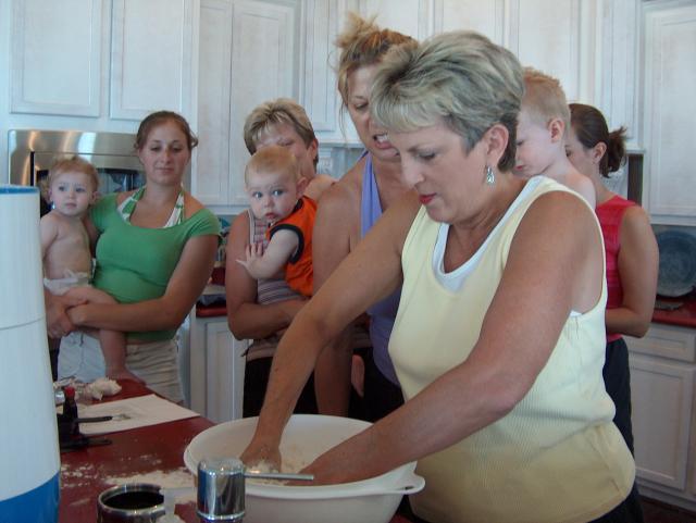 Bebe kneading the dough -- and everyone looking on