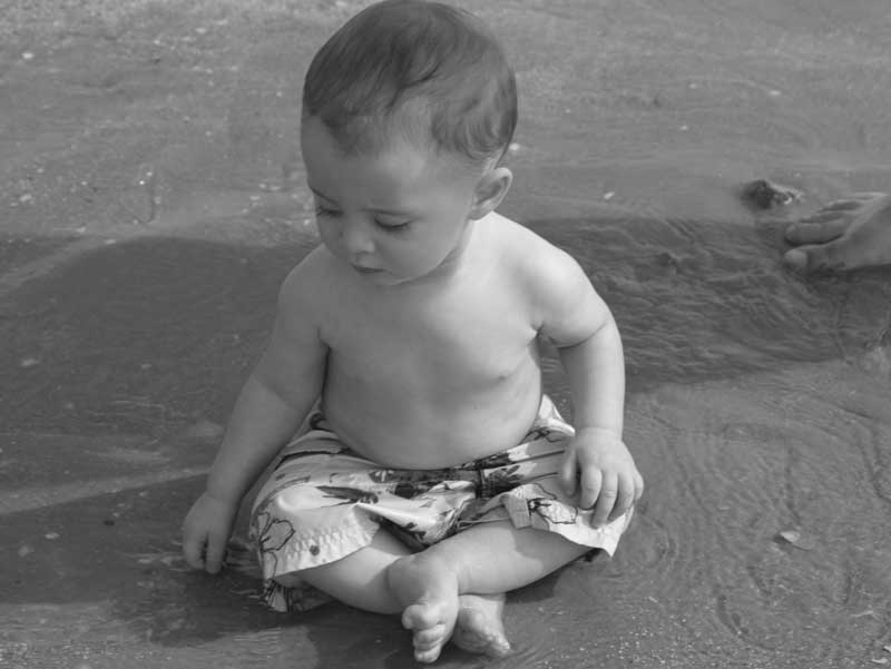 Sitting in the sand (before he toppled over and ate some)