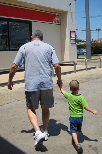 Papa and Tyler running off some energy at a gas stop