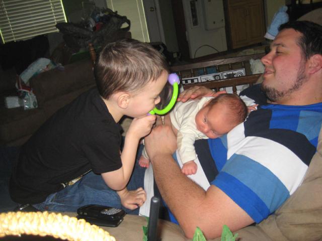 Getting a closer look at baby brother with his magnifying glass ~ April 18, 2009