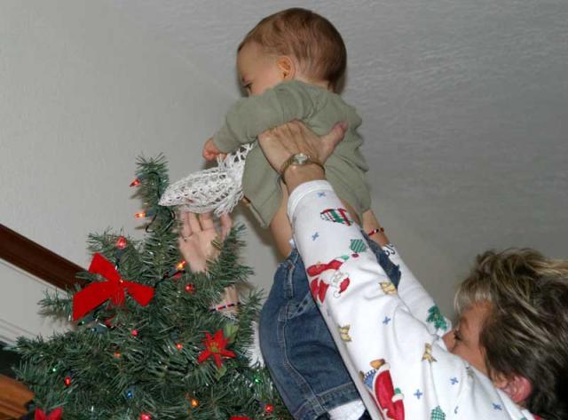 Putting the angel on Gammy's tree ~ December 1, 2006