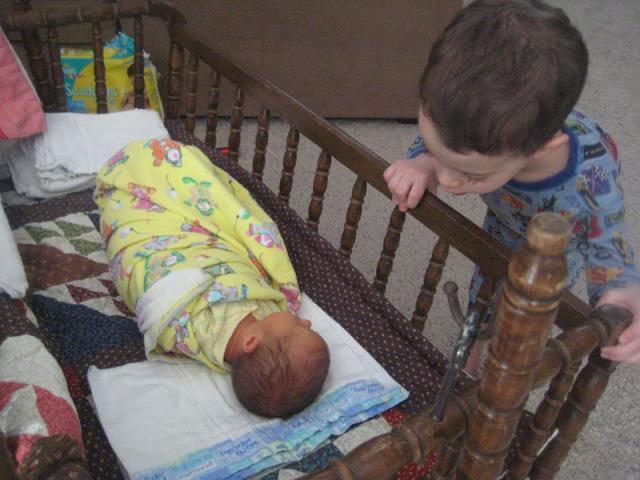 Big brother checking on baby brother first thing in the morning ~ March 2, 2009