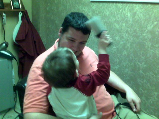 Brushing Dada off after his haircut ~ December 5, 2007