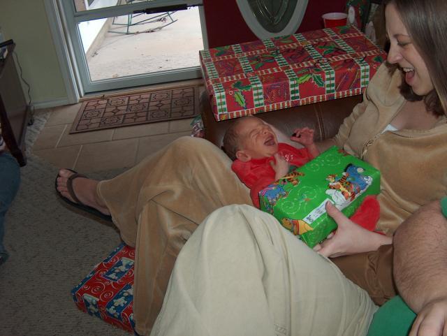 Tyler screams at his present, and Mommy thinks it's funny to scream back!