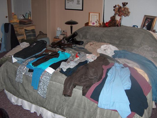 Our clothes-covered bed (a.k.a. packing)