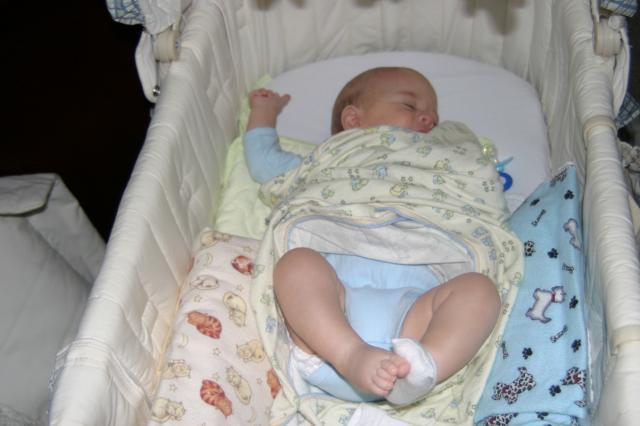 ...and he's broken out of the swaddle and lost a sock.