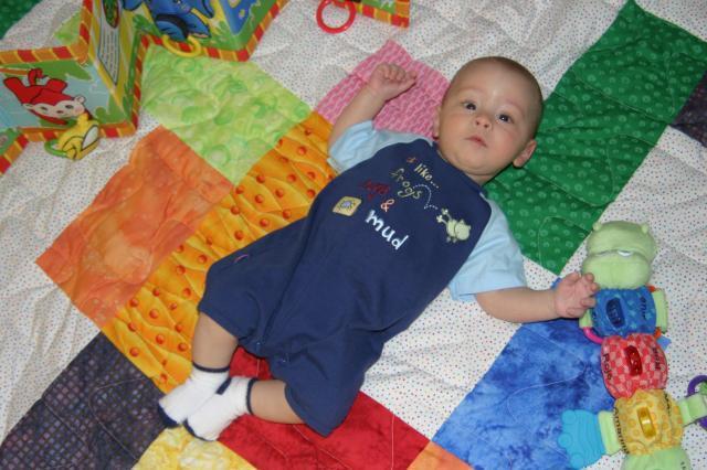 I like frogs, bugs & mud (or so his onesie says)