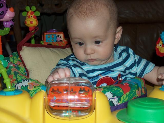 Playing in the exersaucer at Nanna's
