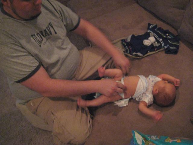 Daddy does the first diaper of the morning