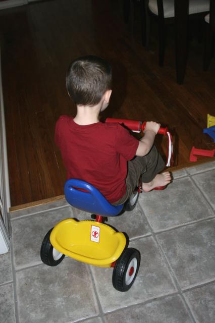 Done with dinner and off on his tricycle