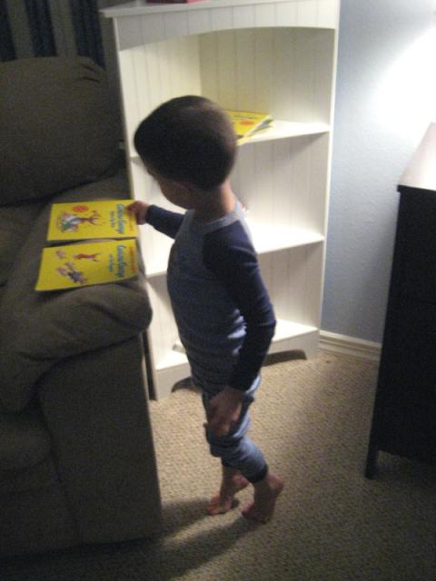 Picking out his bedtime books - more Curious George!